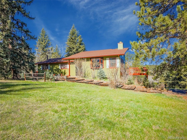 8473 Gray Fox Dr, Evergreen, CO 80439 - back of house featuring a chimney and a yard