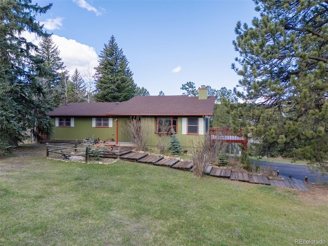 8473 Gray Fox Dr, Evergreen, CO 80439 - rear view of house with a yard and a chimney