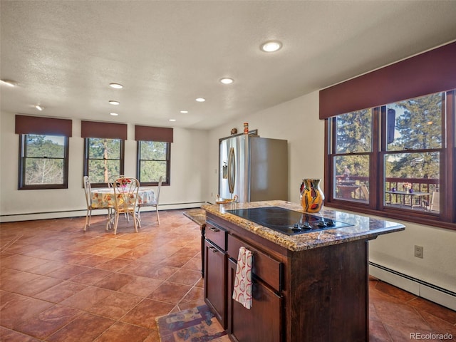 8473 Gray Fox Dr, Evergreen, CO 80439 - kitchen featuring light stone counters, black electric stovetop, baseboard heating, recessed lighting, and stainless steel refrigerator with ice dispenser