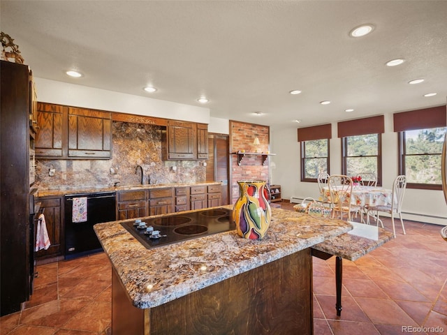 8473 Gray Fox Dr, Evergreen, CO 80439 - kitchen with a breakfast bar, recessed lighting, decorative backsplash, dark tile patterned floors, and black appliances