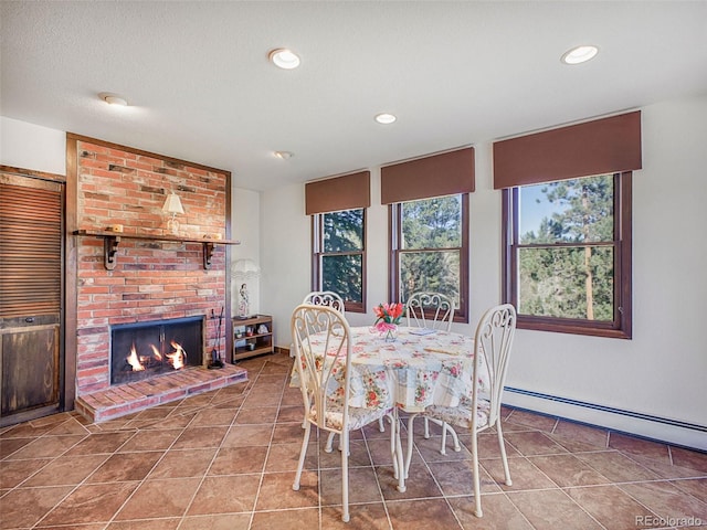 8473 Gray Fox Dr, Evergreen, CO 80439 - tiled dining area featuring recessed lighting, a baseboard radiator, baseboards, and a fireplace