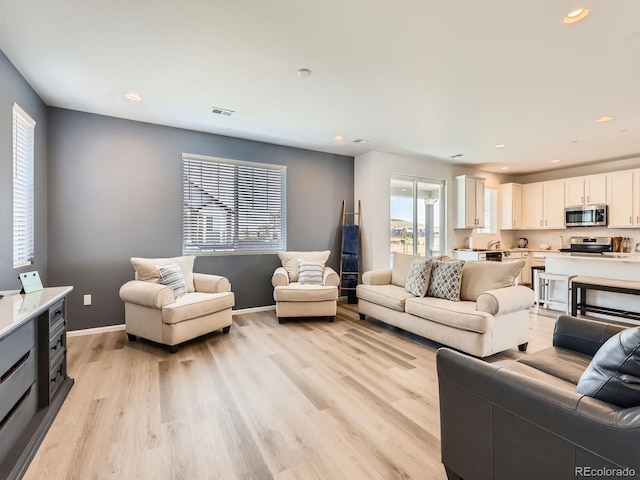 9054 Truckee Ct, Commerce City, CO 80022 - living area featuring light wood-style flooring and recessed lighting