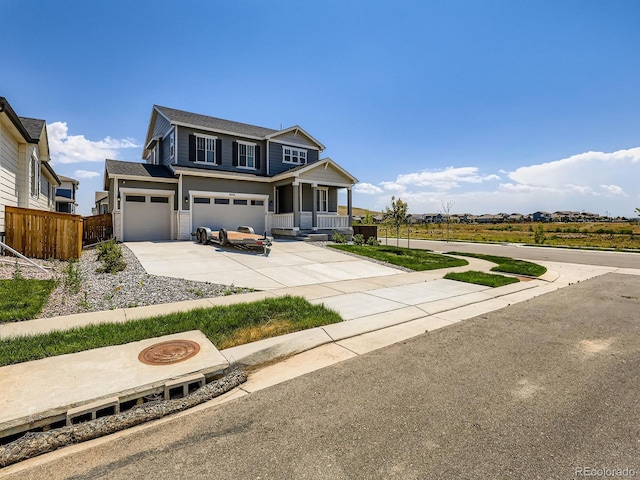 9054 Truckee Ct, Commerce City, CO 80022 - view of front facade featuring driveway, a porch, and an attached garage