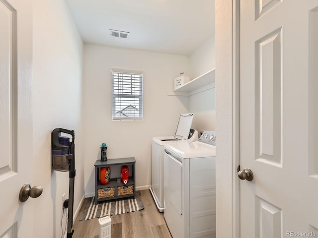 9054 Truckee Ct, Commerce City, CO 80022 - laundry room featuring washing machine and clothes dryer and light wood-style floors