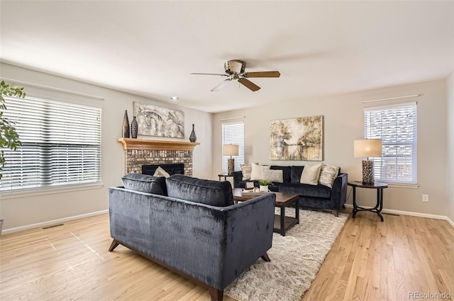 1516 Saltbush Ridge Rd, Highlands Ranch, CO 80126 - living area with visible vents, baseboards, ceiling fan, a fireplace, and light wood finished floors