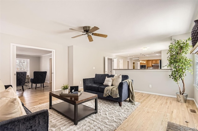 1516 Saltbush Ridge Rd, Highlands Ranch, CO 80126 - living area featuring visible vents, light wood-style flooring, a ceiling fan, and baseboards