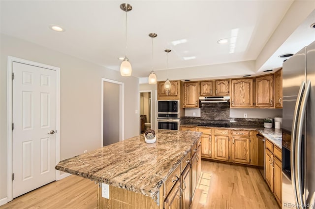 1516 Saltbush Ridge Rd, Highlands Ranch, CO 80126 - kitchen featuring light wood-style flooring, under cabinet range hood, black appliances, and stone countertops