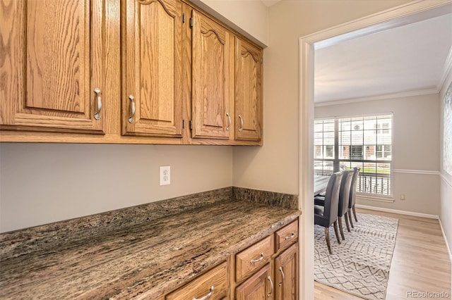 1516 Saltbush Ridge Rd, Highlands Ranch, CO 80126 - kitchen featuring crown molding, light wood-style flooring, and brown cabinets