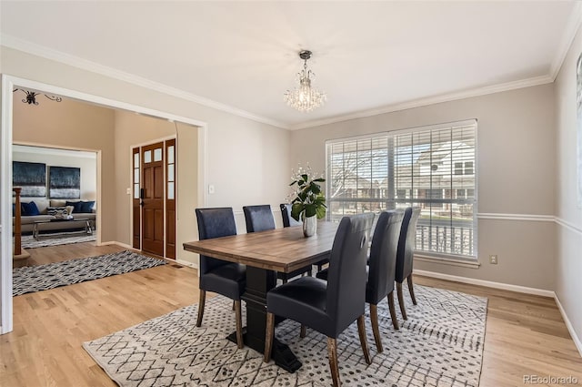1516 Saltbush Ridge Rd, Highlands Ranch, CO 80126 - dining room with a chandelier, light wood finished floors, baseboards, and ornamental molding