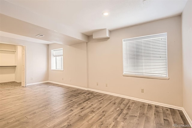 1516 Saltbush Ridge Rd, Highlands Ranch, CO 80126 - unfurnished bedroom with wood finished floors, baseboards, a spacious closet, and visible vents