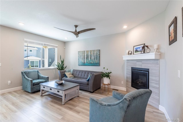 9843 Rosalee Peak St, Littleton, CO 80125 - living room featuring a ceiling fan, wood finished floors, a fireplace, baseboards, and recessed lighting