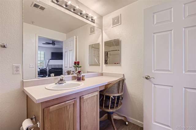 bathroom featuring hardwood / wood-style flooring, ceiling fan, and vanity