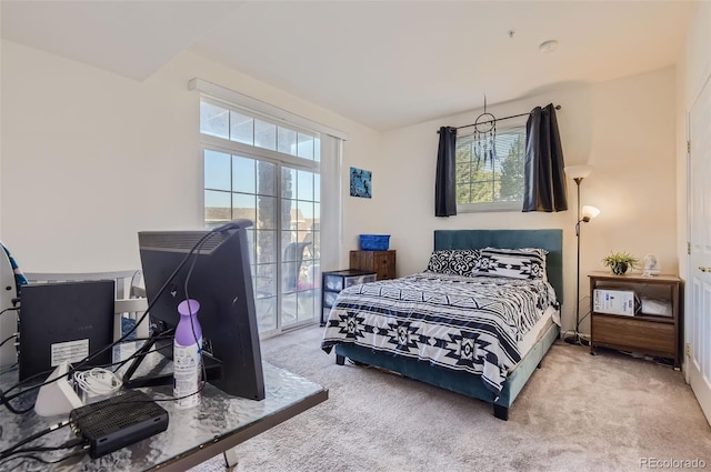 bedroom featuring light colored carpet