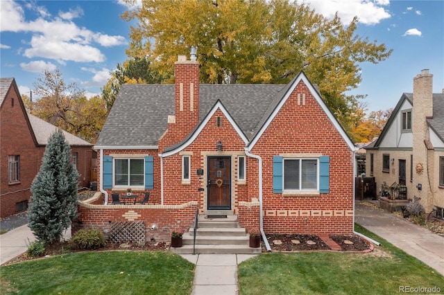 tudor house with a front yard