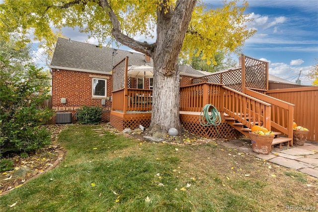 view of yard featuring central AC unit and a deck