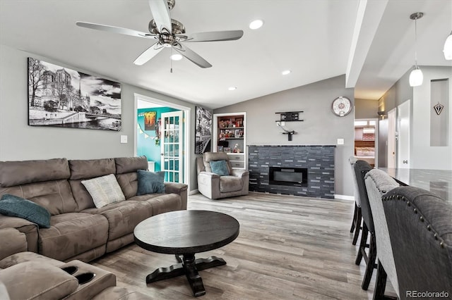 living room with recessed lighting, a tiled fireplace, a ceiling fan, vaulted ceiling, and wood finished floors