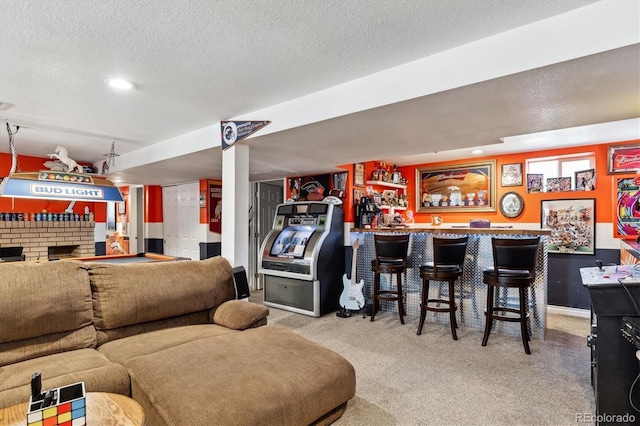 carpeted living area with a fireplace, a textured ceiling, and a bar