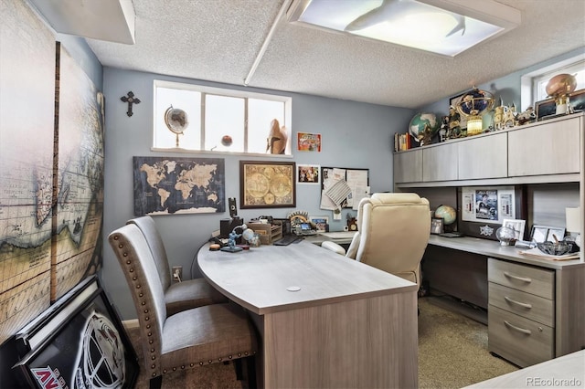 home office featuring a textured ceiling and carpet