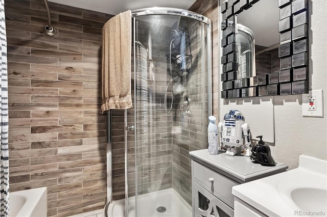 full bathroom with a tub to relax in, a shower stall, and vanity