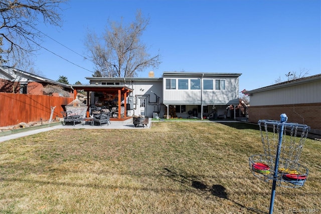 back of property with a yard, a patio, and fence