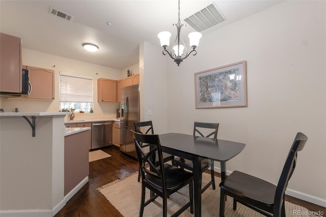 8338 S Independence Cir Unit 108, Littleton, CO 80128 - dining area with a chandelier and dark wood-type flooring