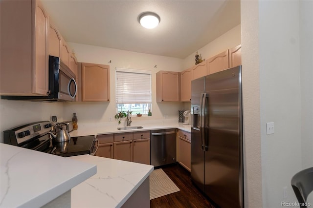 8338 S Independence Cir Unit 108, Littleton, CO 80128 - kitchen with stainless steel appliances, light stone countertops, dark wood finished floors, and a peninsula