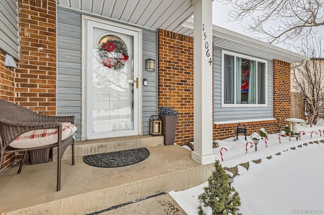 view of snow covered property entrance