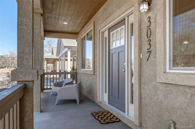 exterior space featuring a porch and stucco siding