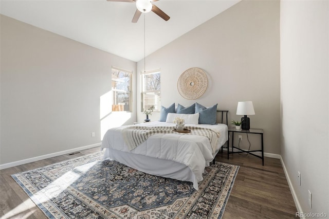 bedroom featuring visible vents, baseboards, lofted ceiling, and wood finished floors