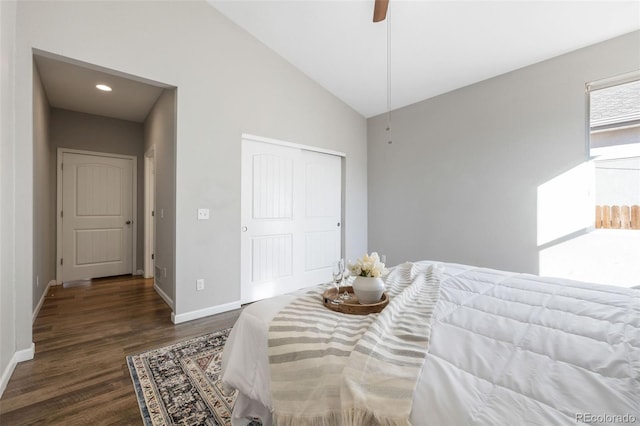 bedroom featuring ceiling fan, baseboards, vaulted ceiling, wood finished floors, and a closet