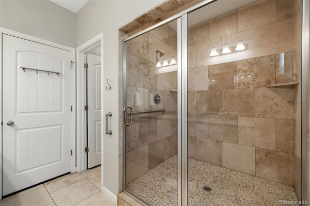 full bathroom featuring tile patterned floors and a shower stall