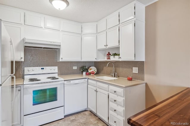 kitchen featuring white cabinetry, sink, a textured ceiling, white appliances, and custom exhaust hood