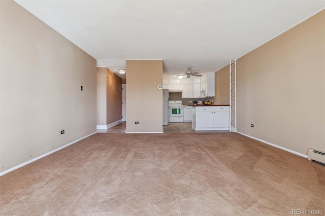 690 S Alton Way Unit 1C, Denver, CO 80247 - unfurnished living room featuring light colored carpet, baseboards, and a ceiling fan