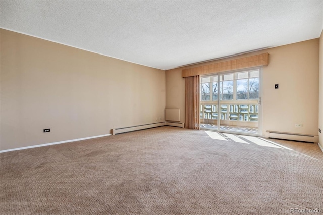 carpeted spare room featuring baseboard heating and a textured ceiling