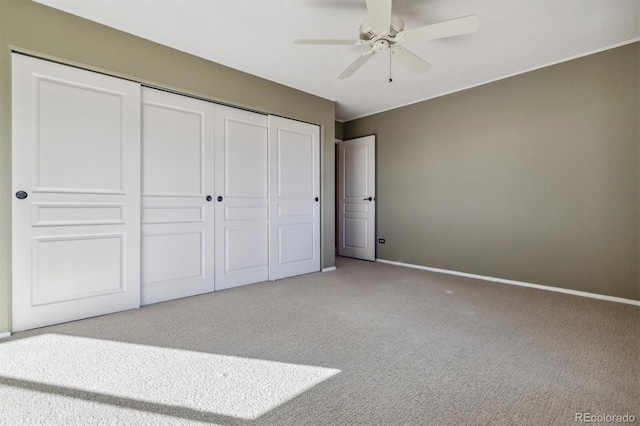 unfurnished bedroom with ceiling fan, light colored carpet, and a closet