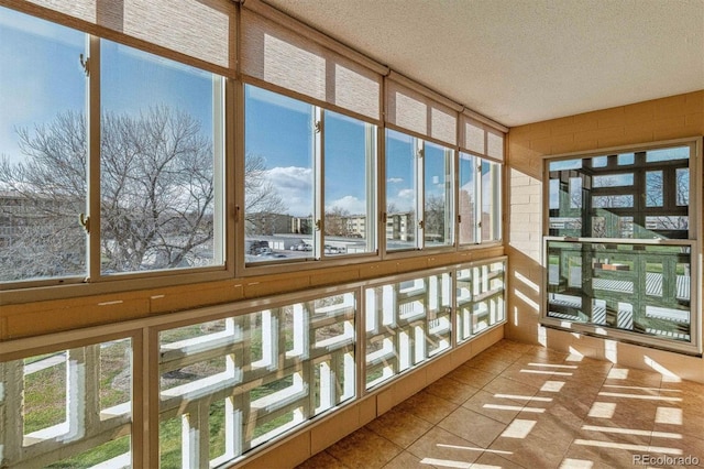 690 S Alton Way Unit 1C, Denver, CO 80247 - unfurnished sunroom featuring tile patterned flooring and a textured ceiling