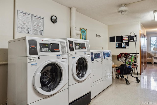 laundry room with a textured ceiling and washer and clothes dryer