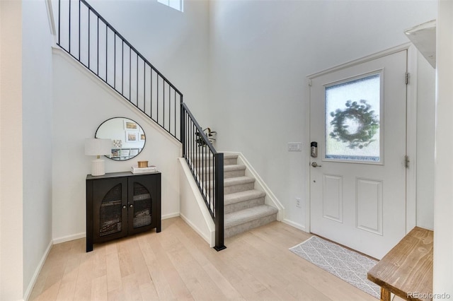 15389 W 50th Dr, Golden, CO 80403 - foyer with light wood-style floors, stairs, baseboards, and a high ceiling