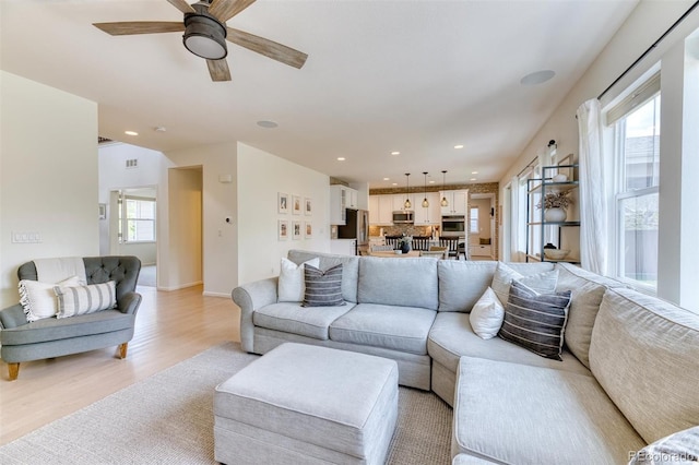 15389 W 50th Dr, Golden, CO 80403 - living area with light wood-type flooring, ceiling fan, and recessed lighting