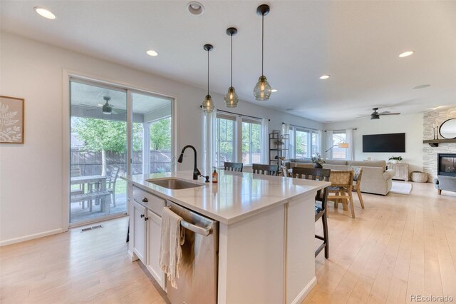15389 W 50th Dr, Golden, CO 80403 - kitchen with a sink, ceiling fan, stainless steel dishwasher, a fireplace, and recessed lighting