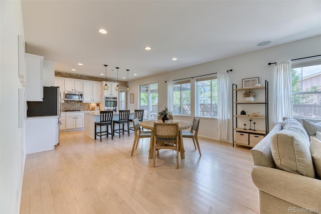 15389 W 50th Dr, Golden, CO 80403 - dining room with healthy amount of natural light, light wood-style floors, and recessed lighting