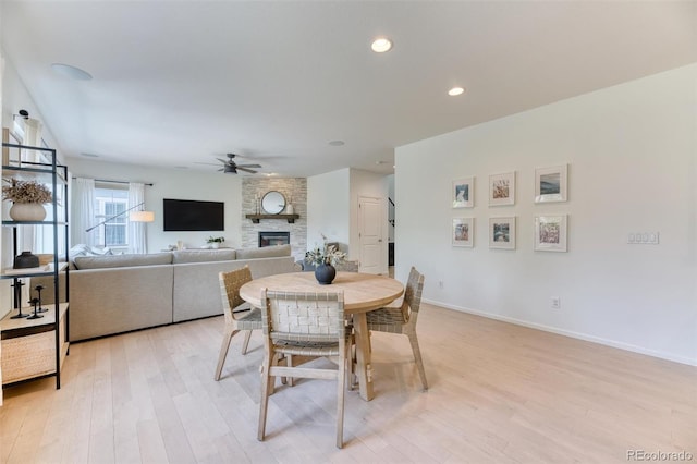 15389 W 50th Dr, Golden, CO 80403 - dining space with a stone fireplace, ceiling fan, light wood-style floors, baseboards, and recessed lighting