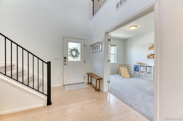 15389 W 50th Dr, Golden, CO 80403 - entrance foyer featuring wood finished floors, stairway, baseboards, and a towering ceiling
