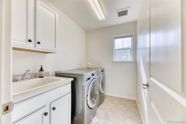 15389 W 50th Dr, Golden, CO 80403 - clothes washing area with cabinet space, washing machine and dryer, baseboards, and light tile patterned flooring