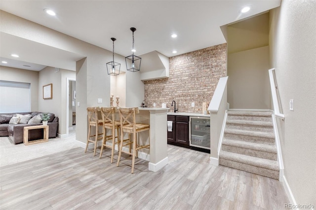 15389 W 50th Dr, Golden, CO 80403 - indoor wet bar with light wood-style flooring, wine cooler, baseboards, and recessed lighting