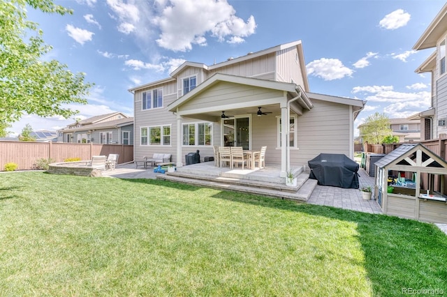 15389 W 50th Dr, Golden, CO 80403 - back of house with ceiling fan, a patio area, an outdoor hangout area, and board and batten siding
