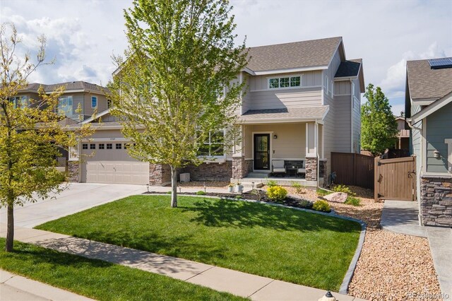 15389 W 50th Dr, Golden, CO 80403 - view of front of property featuring stone siding, driveway, board and batten siding, a shingled roof, and a gate