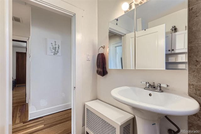 bathroom with hardwood / wood-style floors and sink