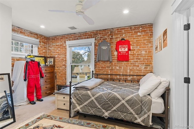 bedroom featuring brick wall, carpet flooring, and ceiling fan