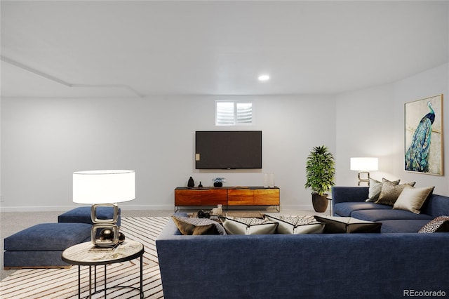 carpeted living area featuring baseboards and recessed lighting